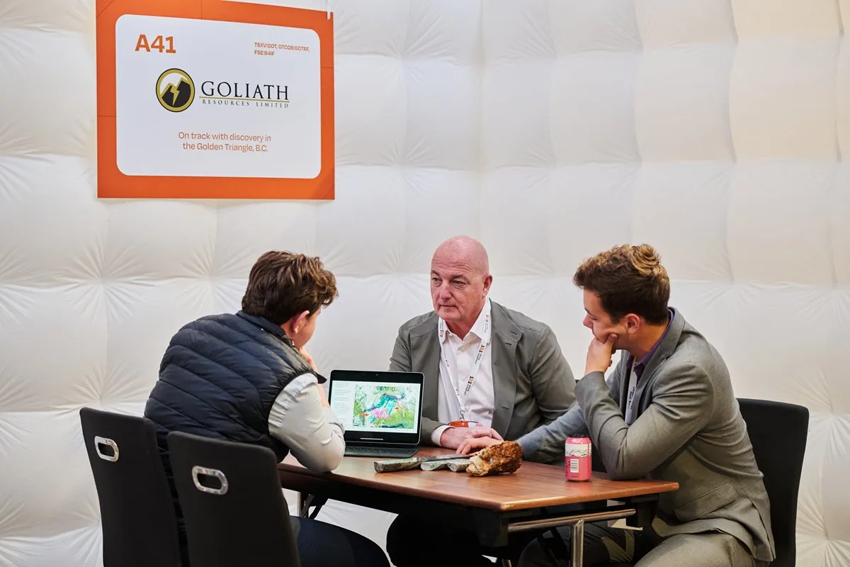 Mining company representatives discussing exploration projects during a 1-2-1 meeting